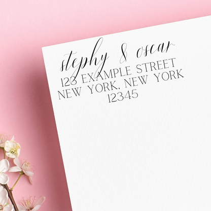 A stamp on white envelope. It reads "stephy & oscar" written in calligraphy, with block letters below. Left on a pink background. A great housewarming gift!