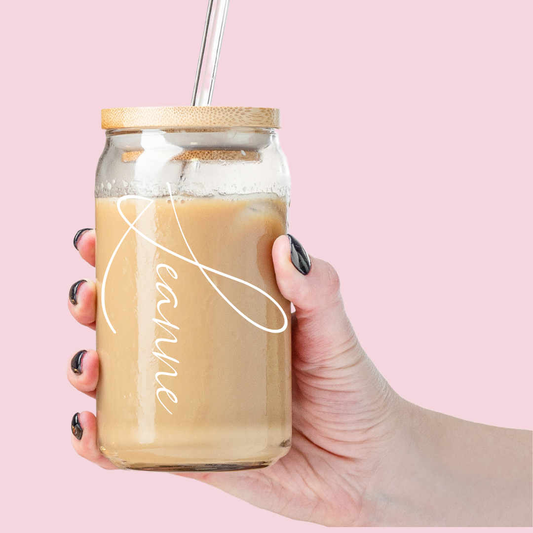 Minimalist coffee tumbler with "Grace" printed on it with coffee inside.