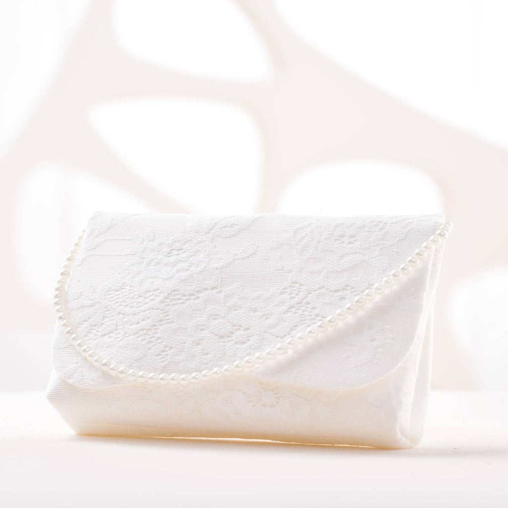 A lace ivory purse with a pearl handle