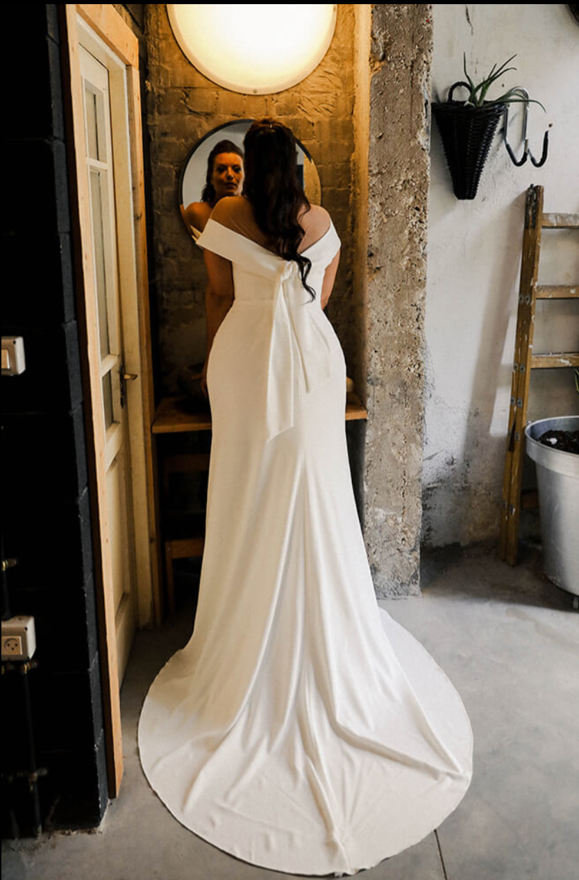 Curvy model showing off the back of the plus size collection 