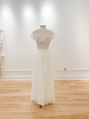 A backless, off-the shoulder, a-line gown with an illusion bodice, with added boning on a mannequin