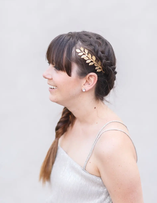 Model wearing Gold Leaf Bridal Comb on the side of their head affixed to a braid