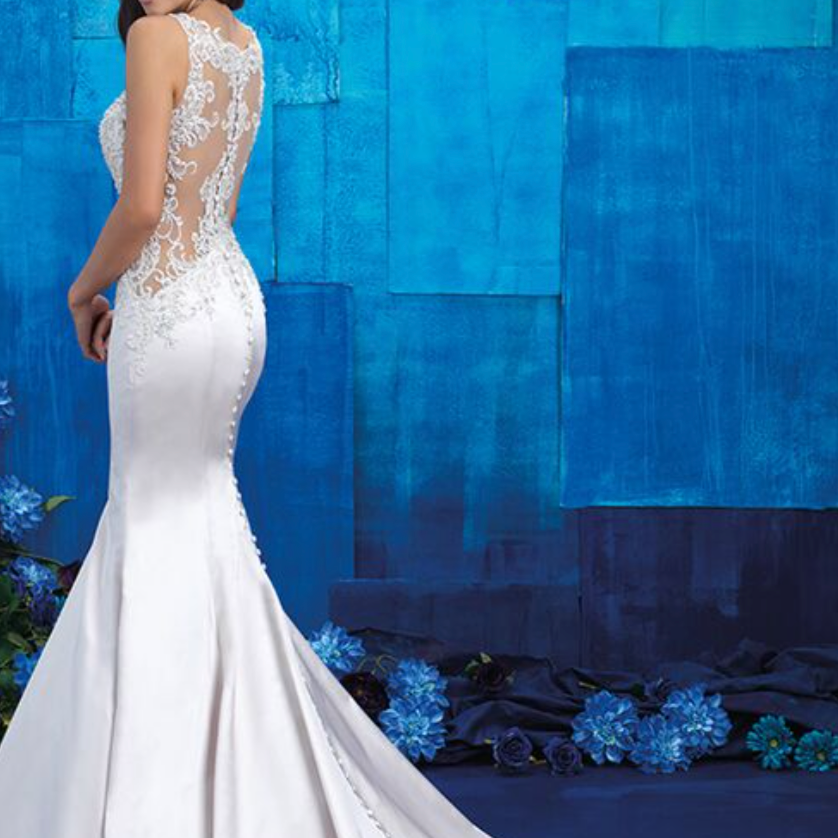 Woman wearing a white mermaid wedding dress with beaded on top - full body back view