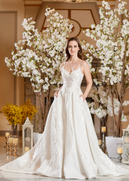 Model wearing Bella by Icon Bridal - a fully beaded ball gown wedding dress, full body front view