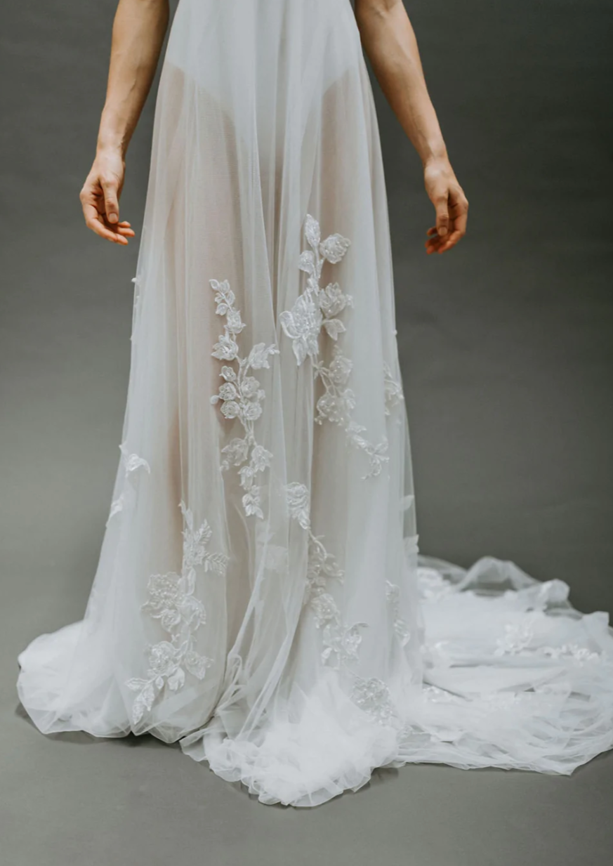 Overskirt made with lux soft tulle hand embellished with lightly beaded lace appliques. 70″ long