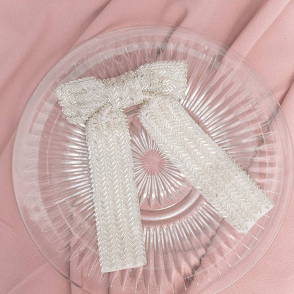 Flat lay of an ivory beaded bow