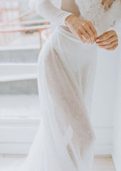 Beautiful made to order pearl overskirt. 4 layers of our Lux Tulle with 1 Layer of our Pearl tulle make this skirt the perfect ethereal topper to any wedding day look.   Hoop and eye and zipper closure back. No gather for a clean and modern look with no added 