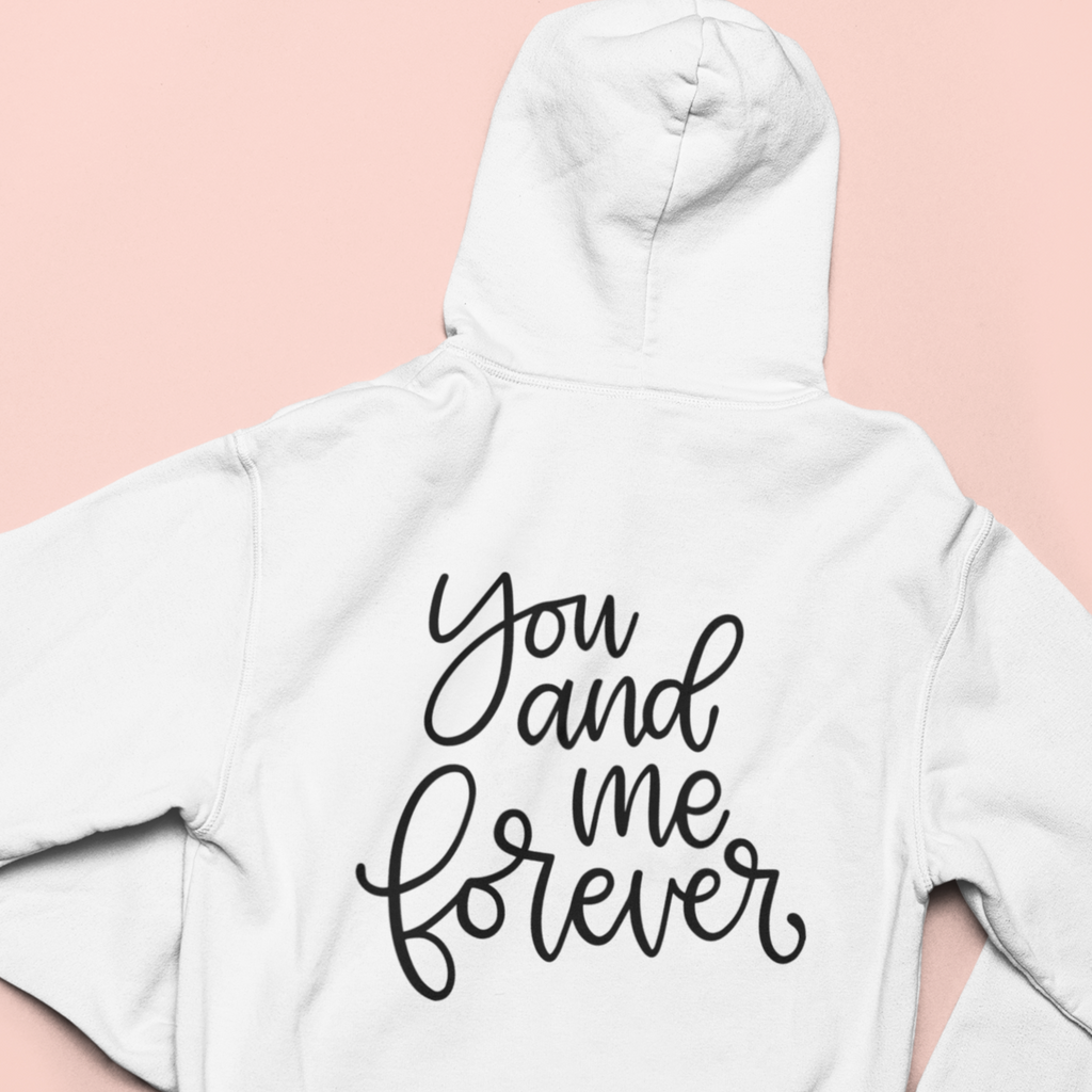 White hoodie with "you and me forever" printed in black on the back