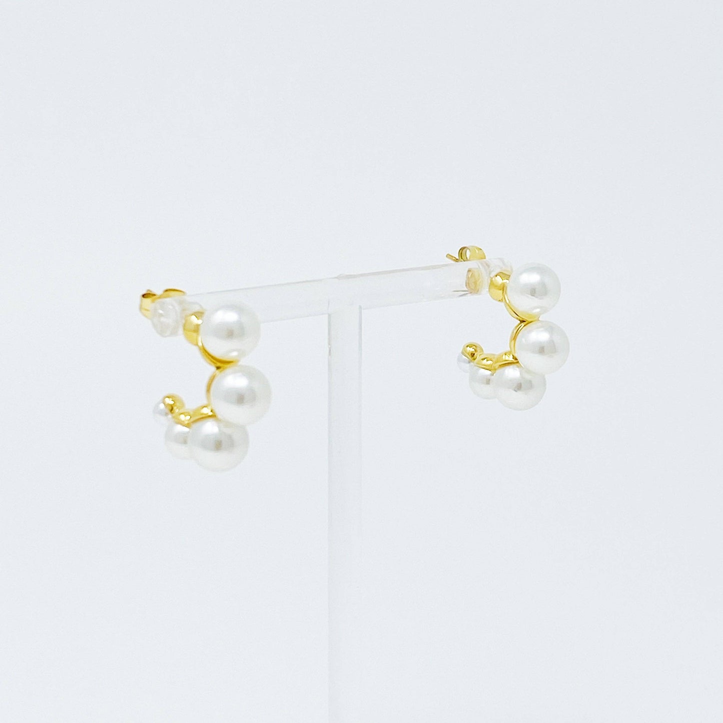Close up photo of small gold hoops with pearls