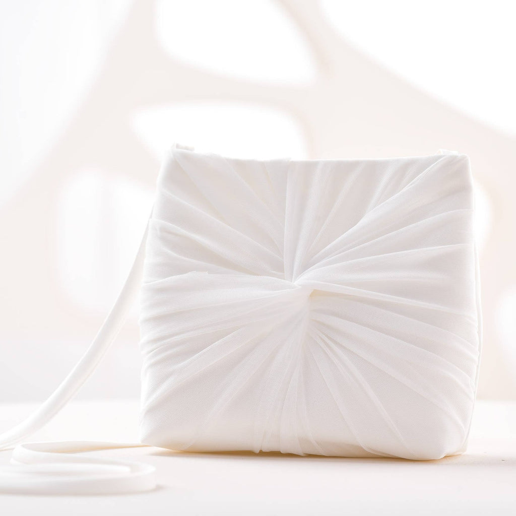 A white rectangular tulle hand bag for the bride.