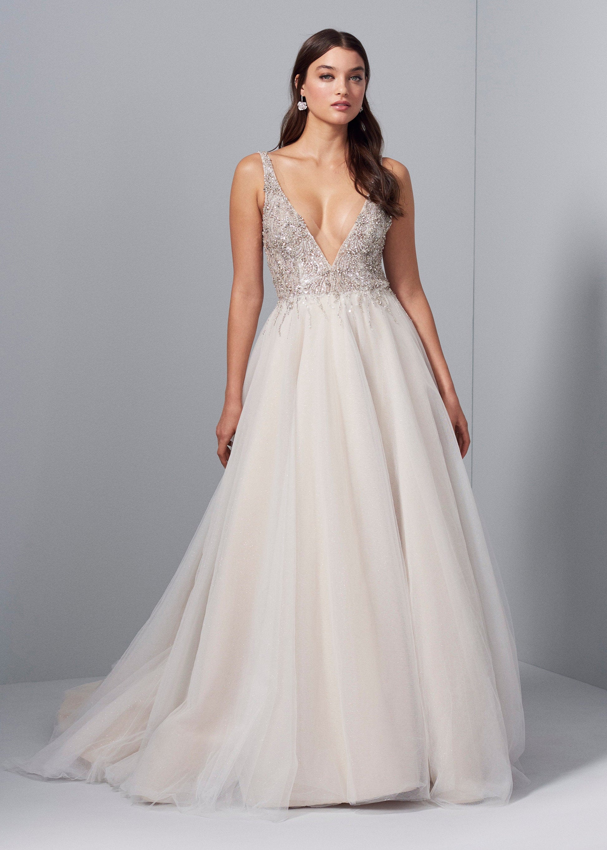 Woman wearing a ball gown wedding dress with a deep V and beaded top