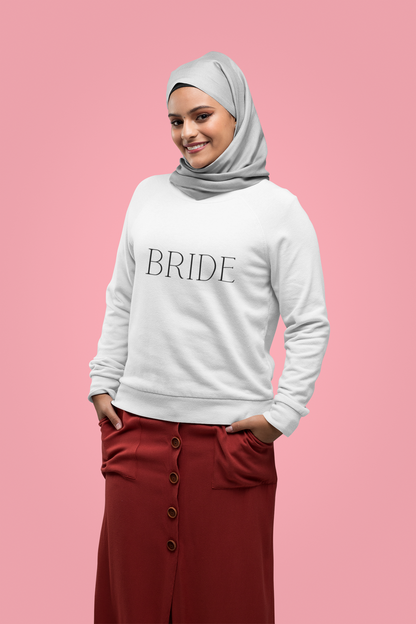 BRIDE written in black text on a white crewneck worn by a young woman